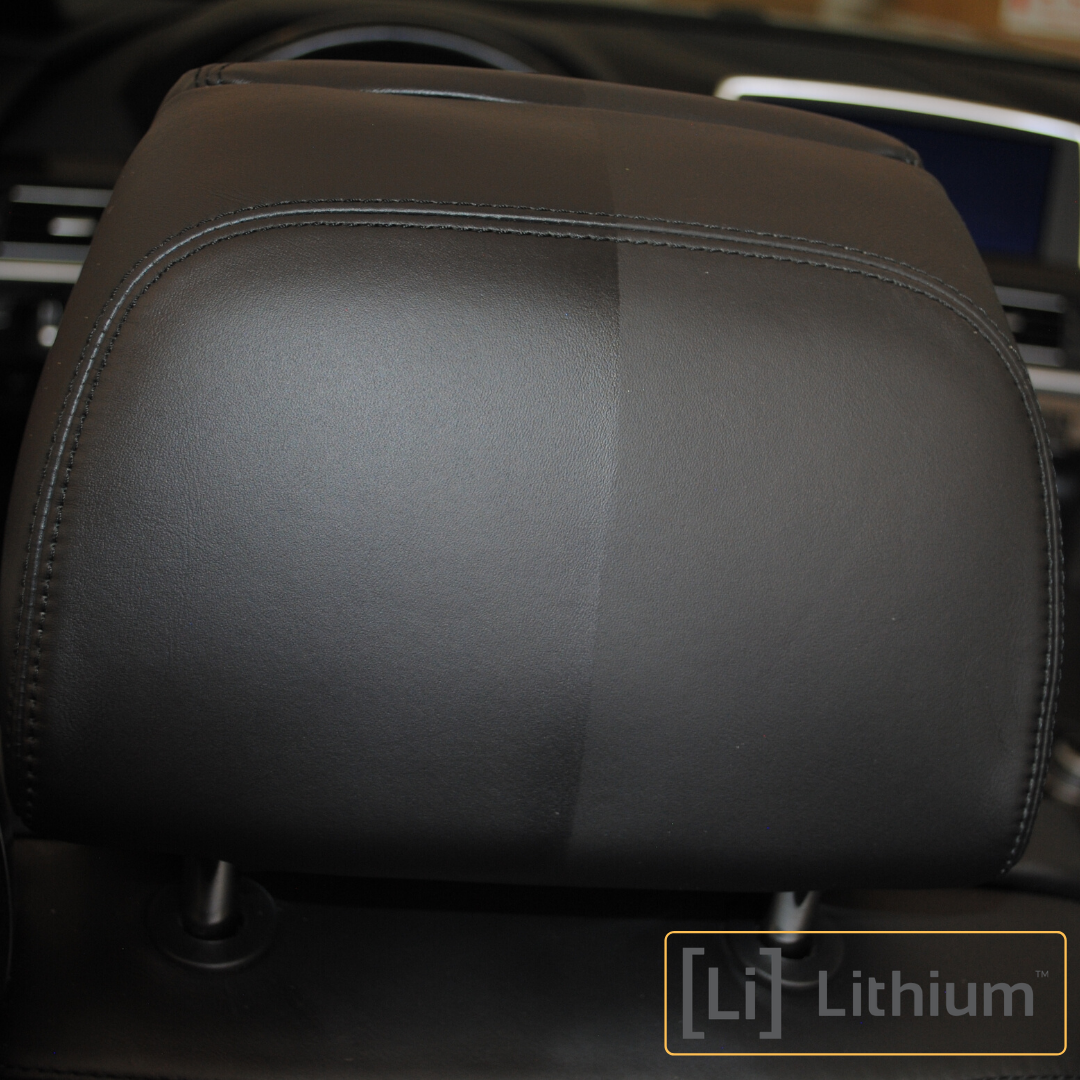 A black leather headrest divided in half. The left side is untreated and appears matte, while the right side has been conditioned with 'Leather Love,' showing a shiny and darker finish